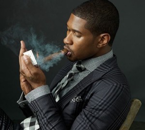 Usher smoking a cigar.
