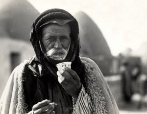A Syrian Bedouin enjoying a cup of Arabic coffee in 1930