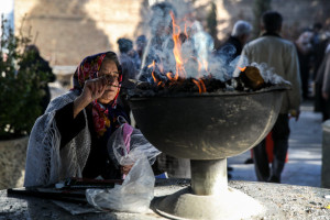 A Zoroastrian woman burns esfand during a 2013 ceremony in Tehran