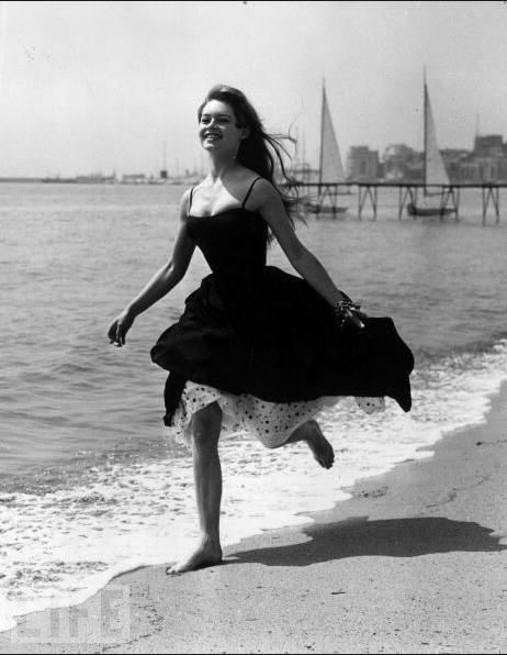 Brigitte Bardot runs barefoot on the sands at Cannes in 1956
