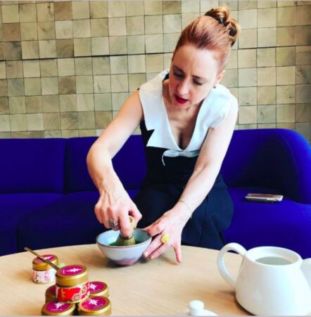 Maria mixing matcha tea with chasen (ceremonial bamboo whisk)